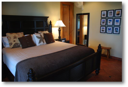 Master bedroom with king size bed, sliding door to veranda and 
view of ocean   
